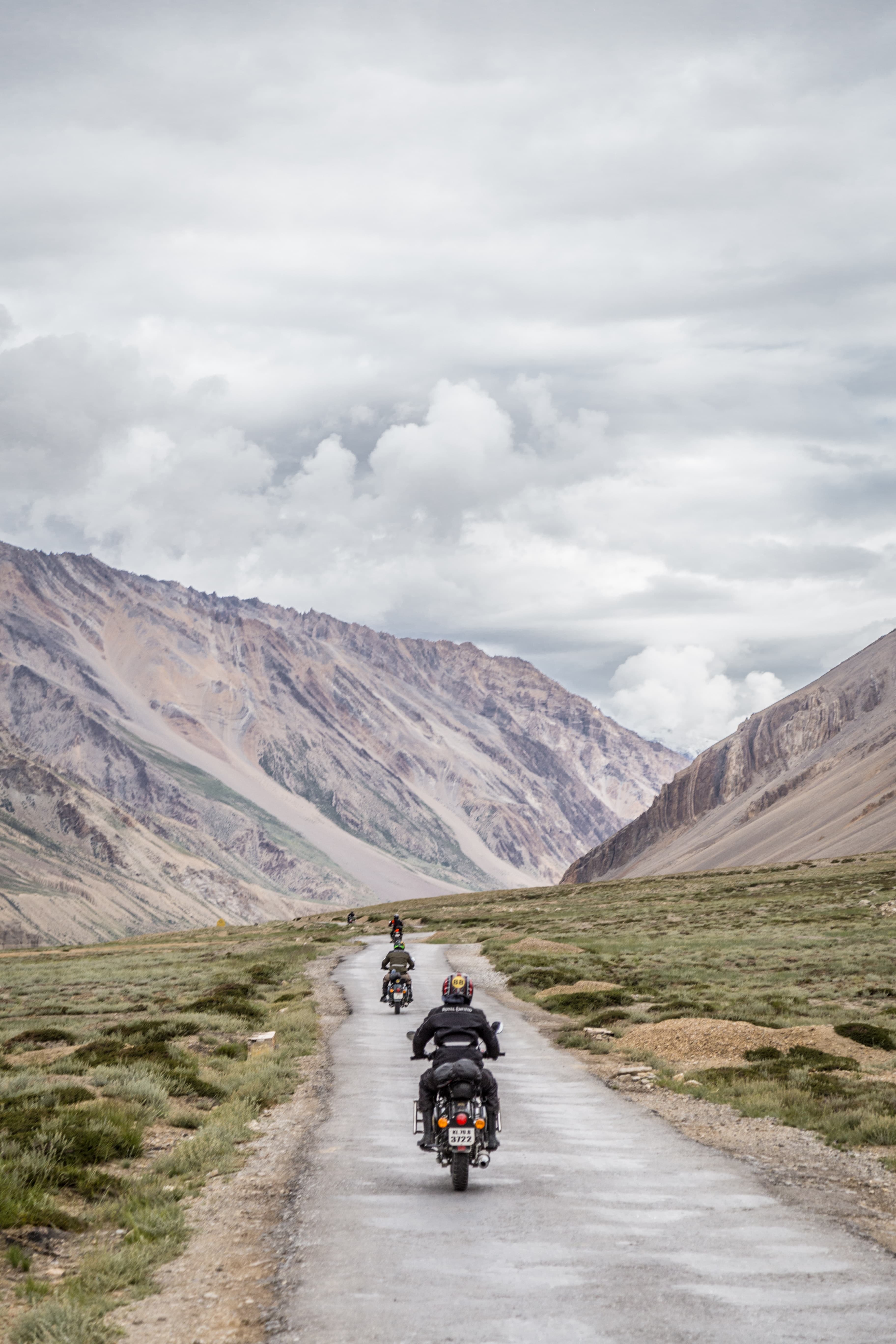 Motorcyclists riding through mountain scenery