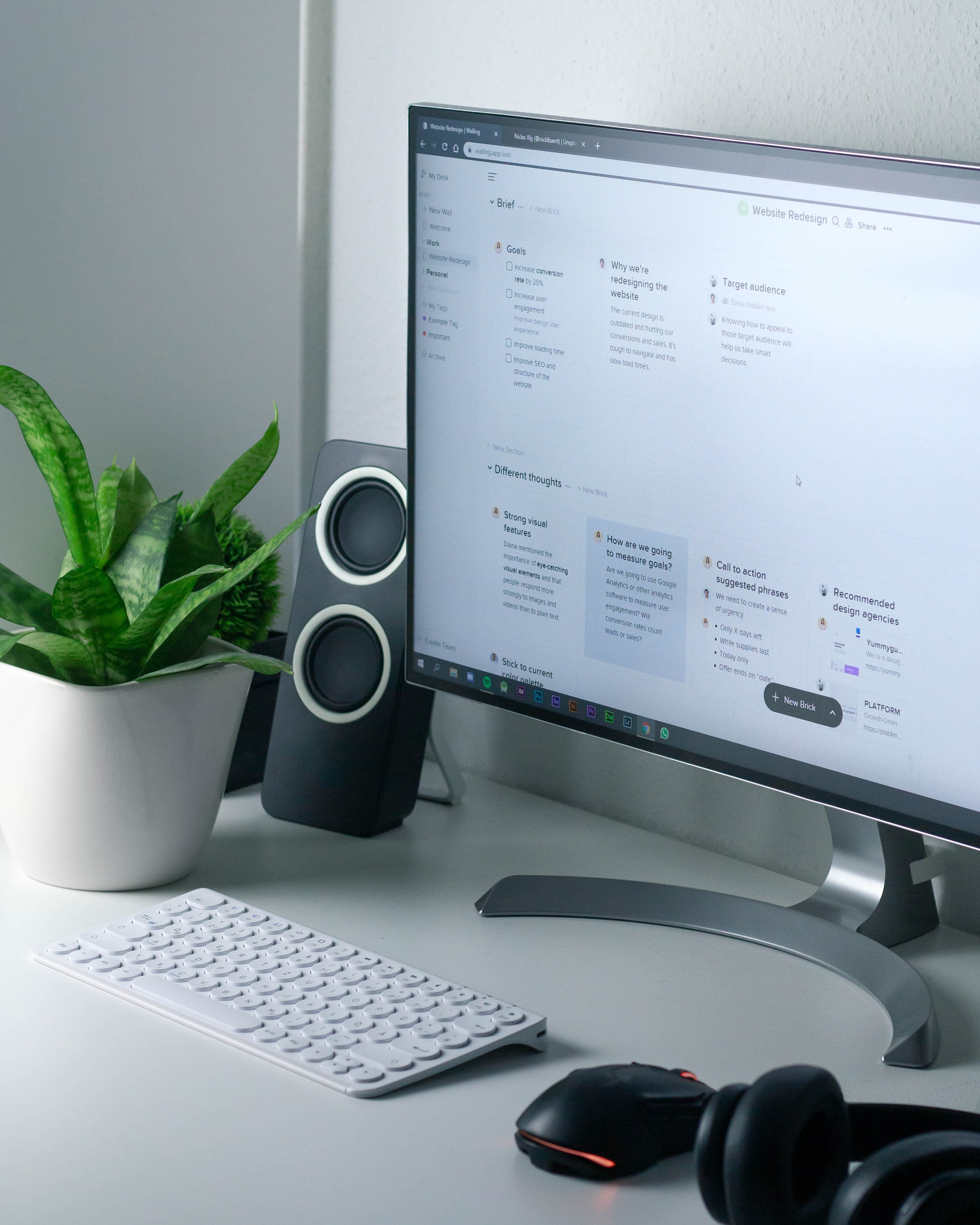 A desk workspace with a laptop and notebook