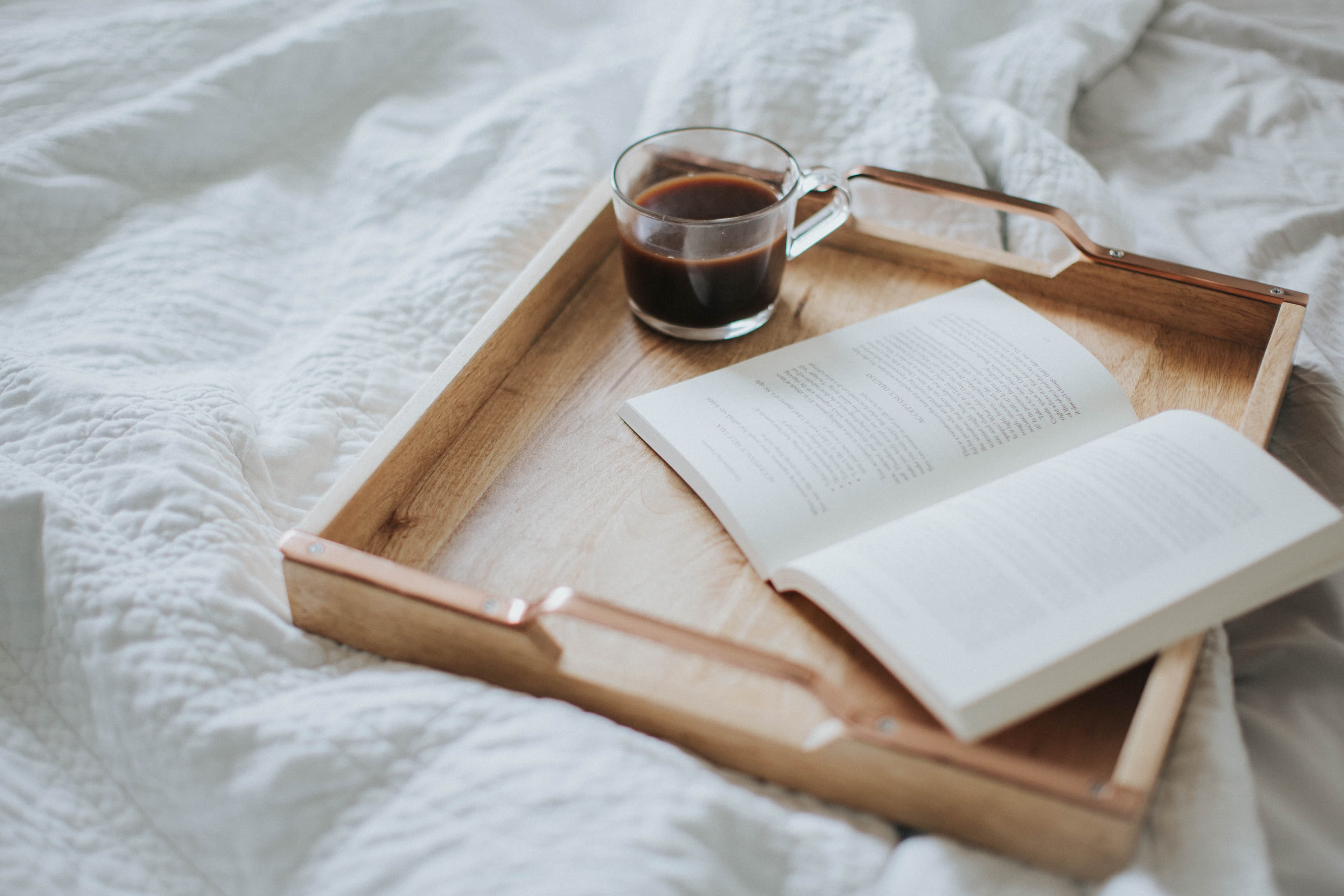 A cafe table with coffee and a notebook
